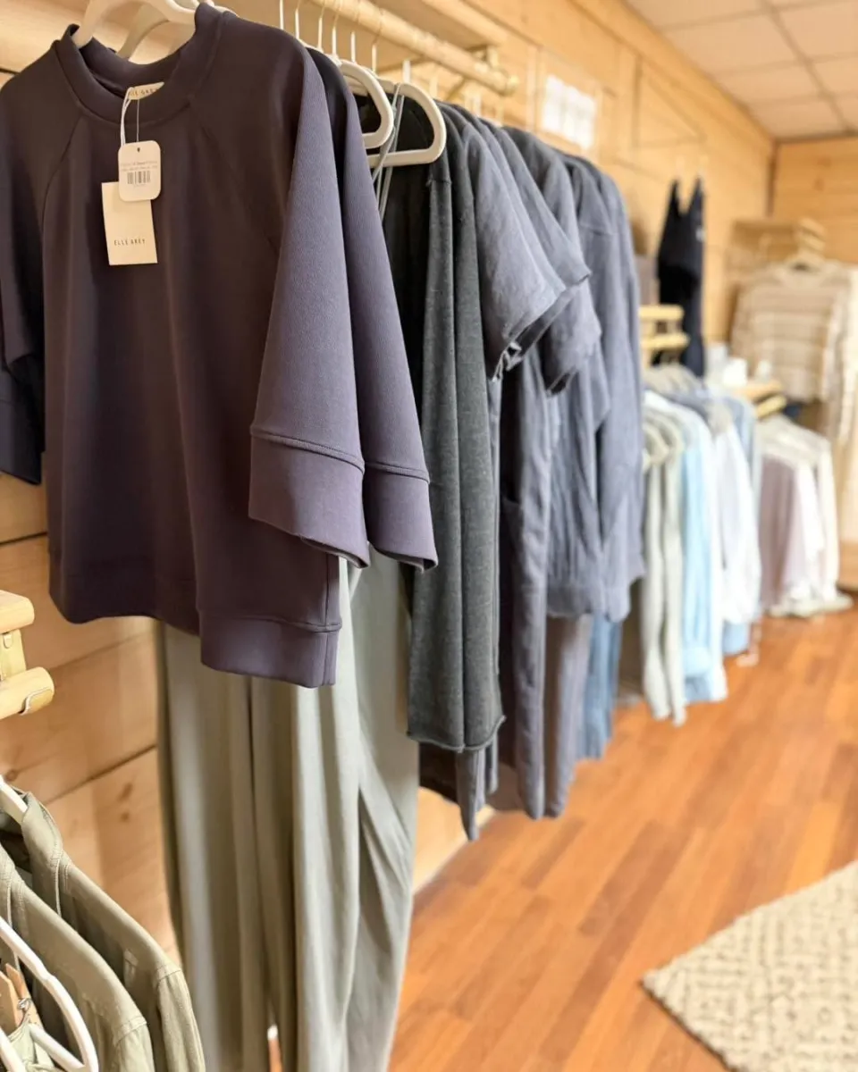 Rack of soft neutral clothing in the upstairs boutique at Vintage 72
