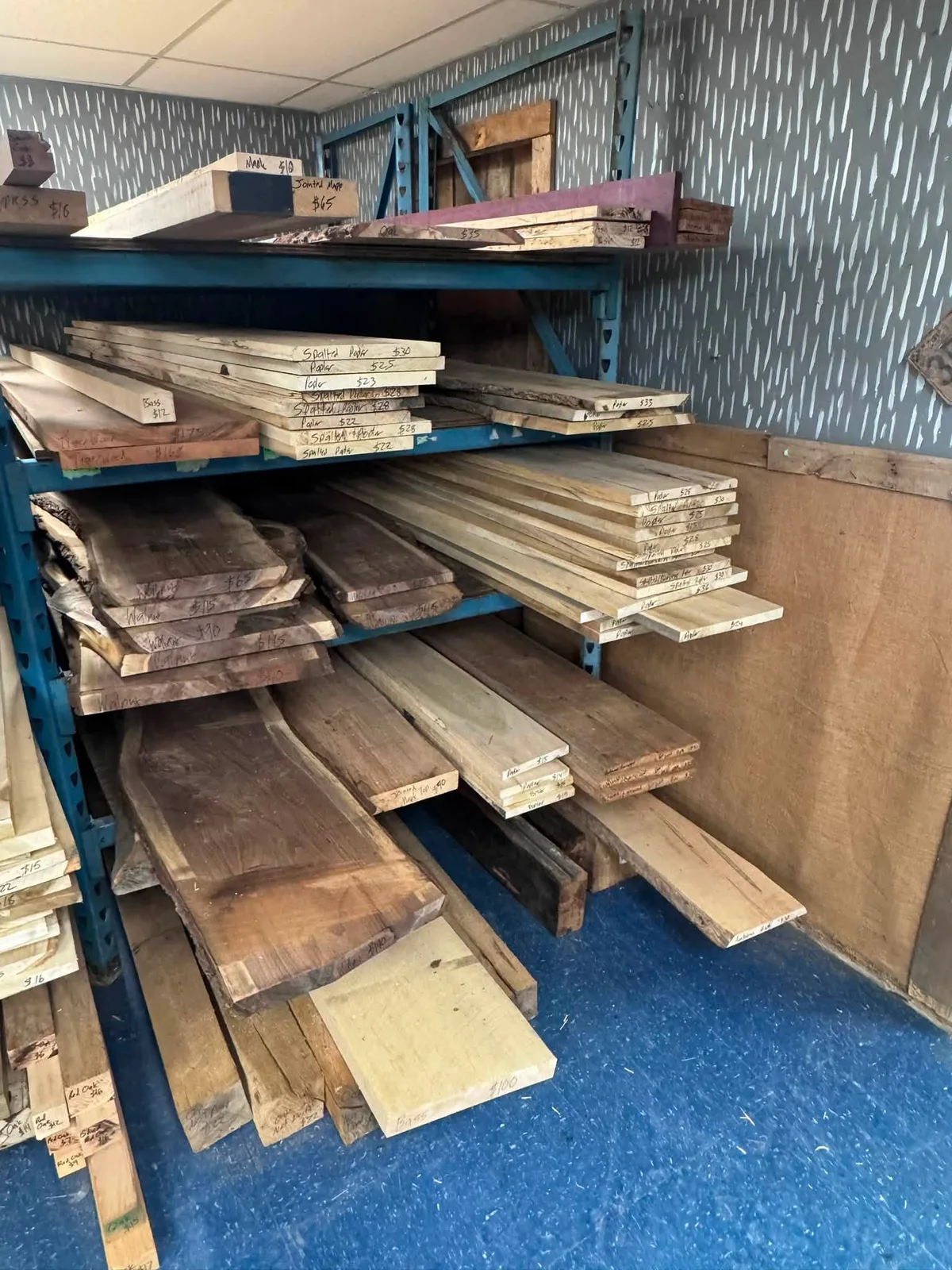 Shelves stacked with specialty lumber and live-edge boards from Fisk Federation at Vintage 72